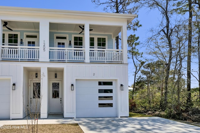 1205 Mackerel Ln Unit 2, Carolina Beach, NC 28428 - view of front of property with a balcony, driveway, board and batten siding, a ceiling fan, and a garage