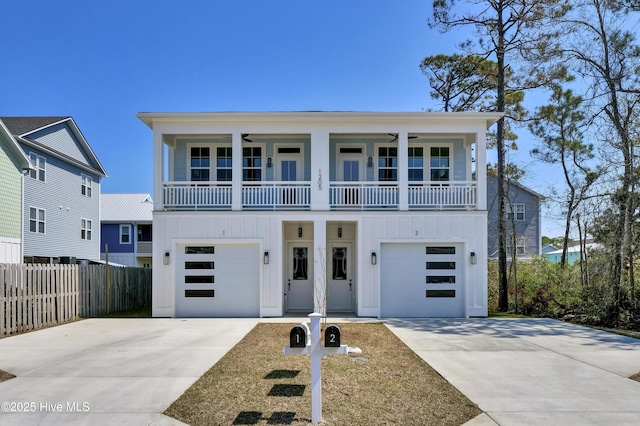 1205 Mackerel Ln Unit 2, Carolina Beach, NC 28428 - view of front of house featuring a garage, driveway, board and batten siding, and a ceiling fan