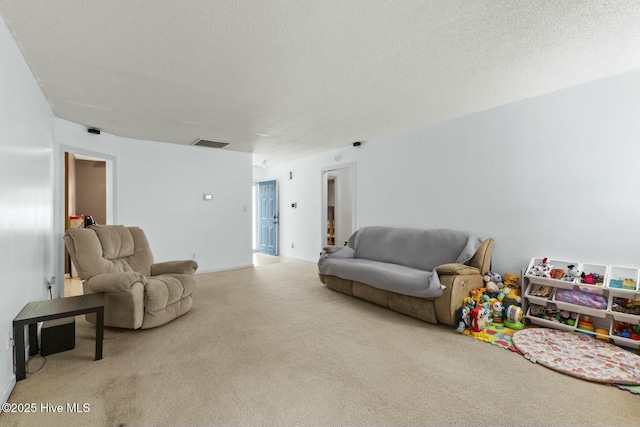 carpeted living room with visible vents and a textured ceiling