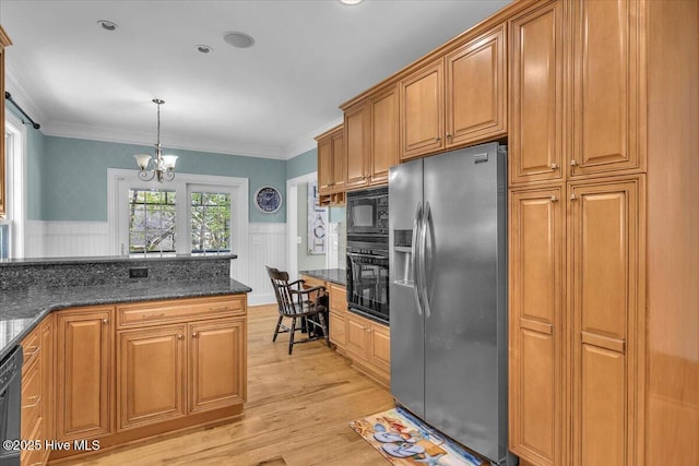 kitchen featuring a notable chandelier, ornamental molding, light wood-style floors, black appliances, and wainscoting