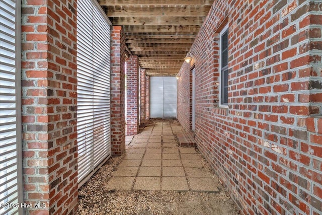 view of side of property featuring brick siding