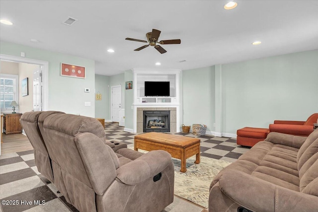 living room with baseboards, a fireplace, recessed lighting, a ceiling fan, and visible vents
