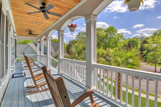wooden deck with a ceiling fan