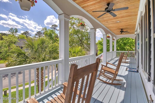 wooden deck featuring ceiling fan and covered porch