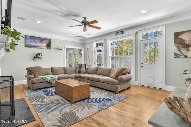 living area with baseboards, ornamental molding, a ceiling fan, recessed lighting, and wood finished floors