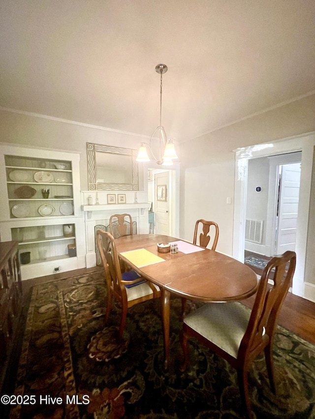 dining area featuring built in features and visible vents