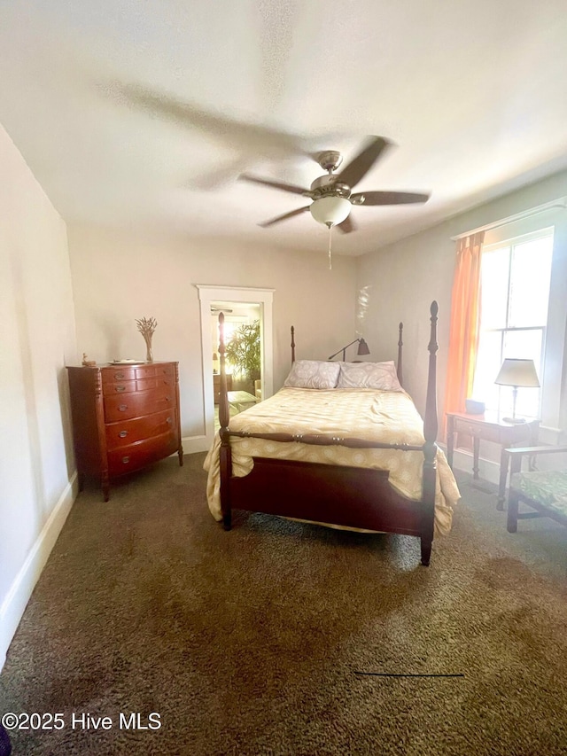 bedroom with a ceiling fan, baseboards, and carpet floors