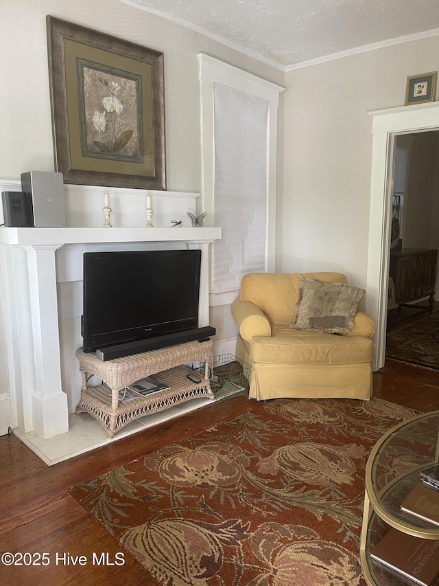 living room with ornamental molding and wood finished floors