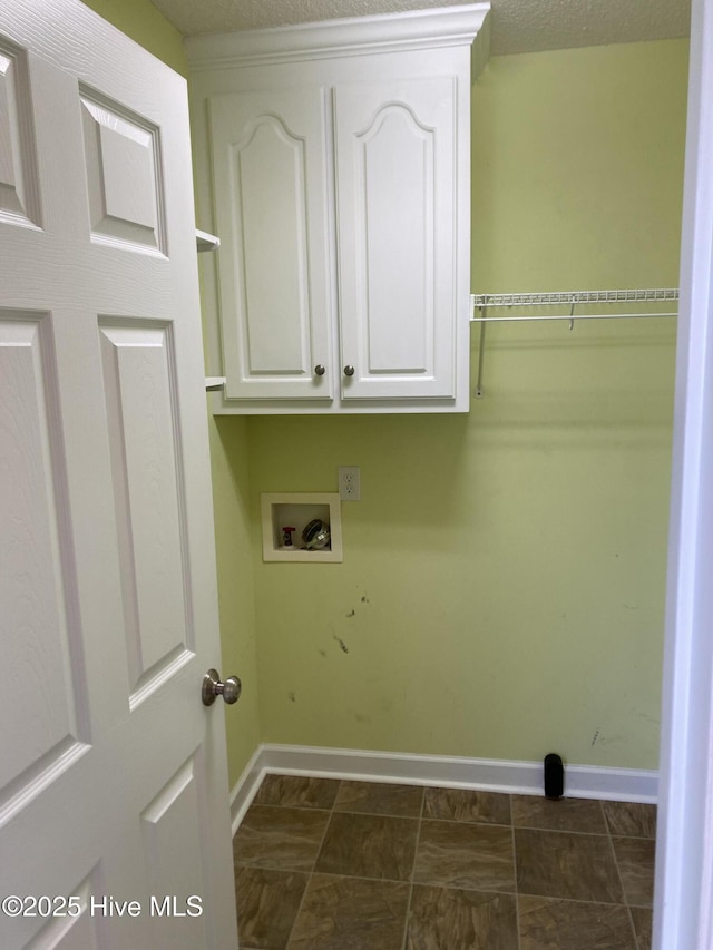 laundry room with cabinet space, baseboards, and washer hookup