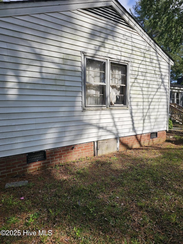 view of side of home with crawl space