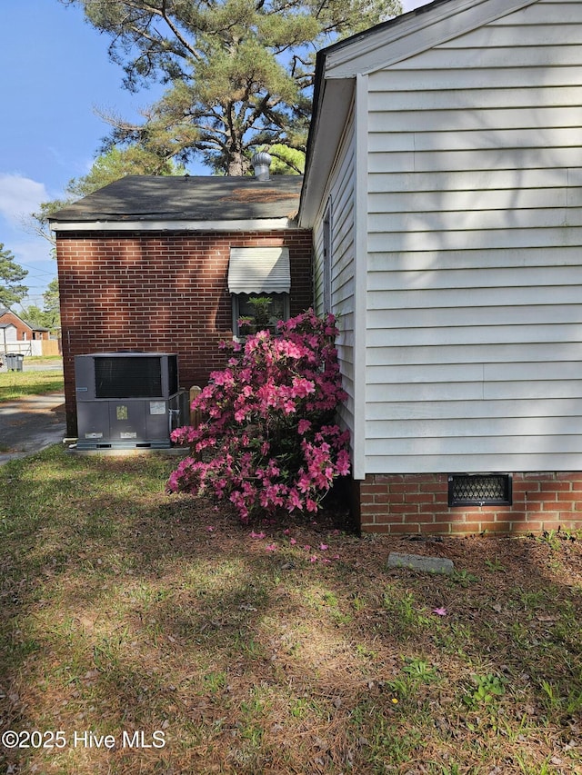 view of property exterior featuring central air condition unit and crawl space