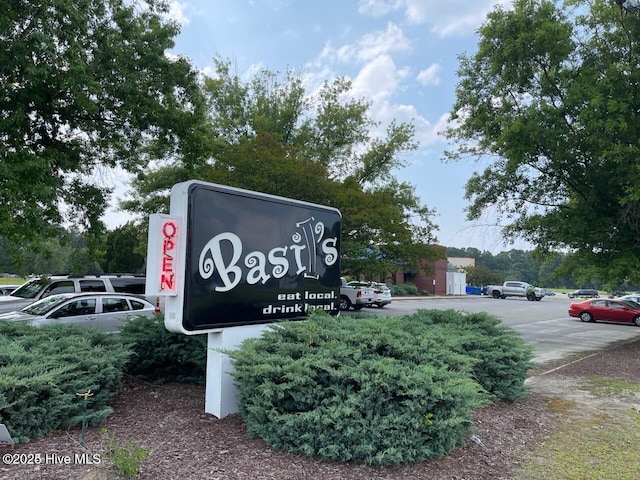 community sign featuring uncovered parking