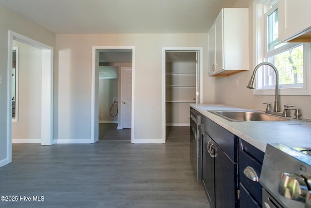 915 N Broad St, Edenton, NC 27932 - kitchen with a sink, stove, white cabinets, light countertops, and baseboards