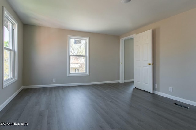 915 N Broad St, Edenton, NC 27932 - spare room featuring dark wood-style floors, healthy amount of natural light, and baseboards