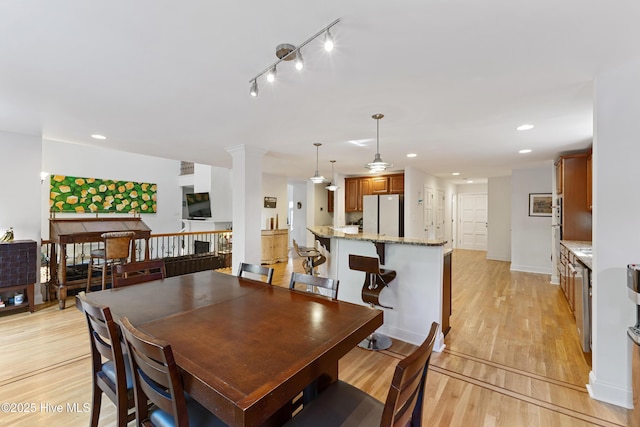 dining room with light wood-style floors and recessed lighting