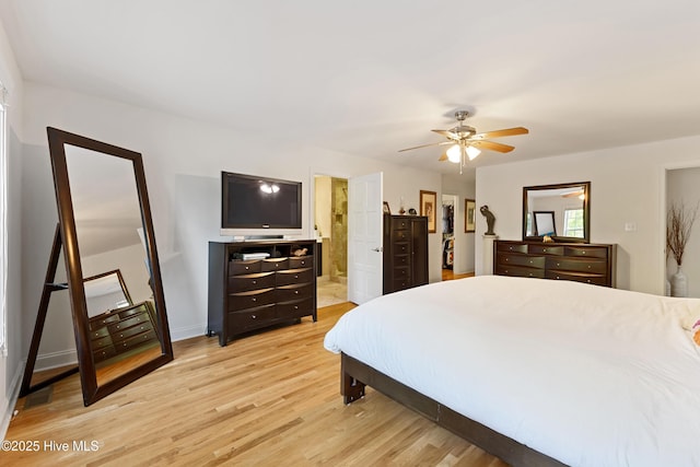 bedroom with ensuite bathroom, baseboards, light wood-type flooring, and ceiling fan