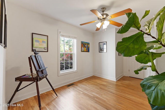 unfurnished room featuring visible vents, baseboards, a ceiling fan, and light wood-style flooring