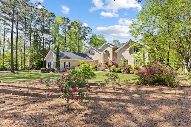 view of front of property with a front yard and brick siding