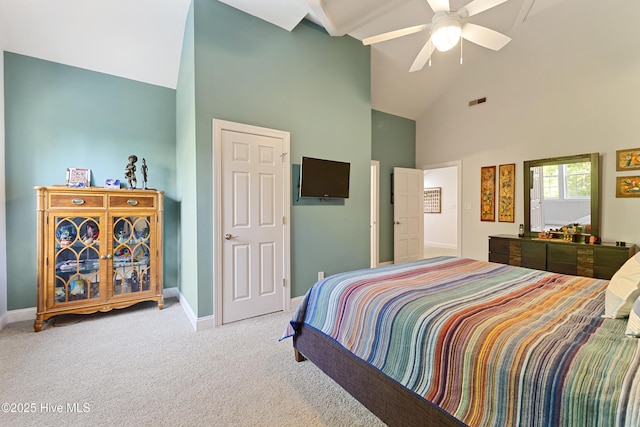 carpeted bedroom with high vaulted ceiling, baseboards, a ceiling fan, and visible vents