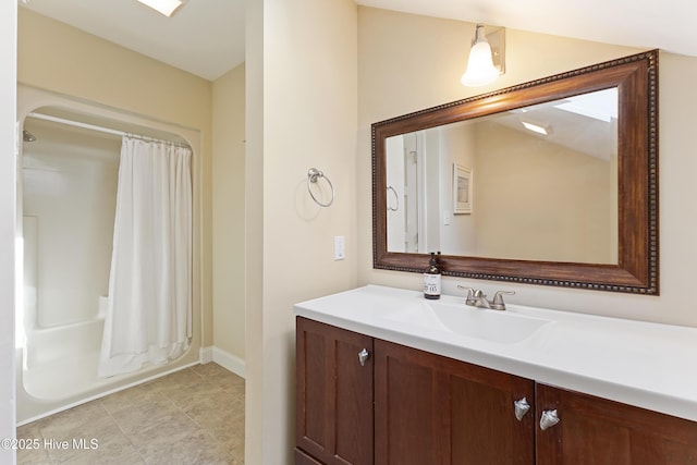 bathroom featuring shower / tub combo, baseboards, and vanity