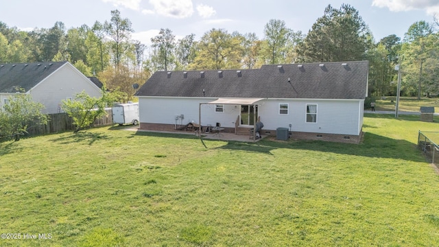 rear view of property featuring a yard, central air condition unit, entry steps, and a fenced backyard