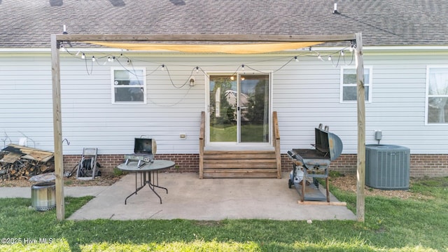 back of property with entry steps, a shingled roof, and central air condition unit