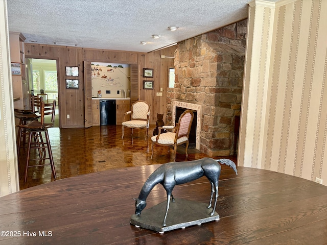 207 Bump A Long Ln, Southern Pines, NC 28387 - sitting room featuring a textured ceiling, wooden walls, and a fireplace