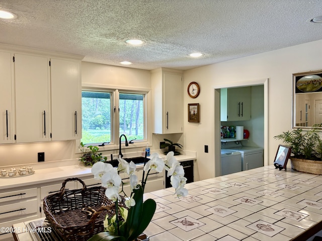207 Bump A Long Ln, Southern Pines, NC 28387 - kitchen featuring white cabinets, a sink, a textured ceiling, recessed lighting, and washing machine and clothes dryer