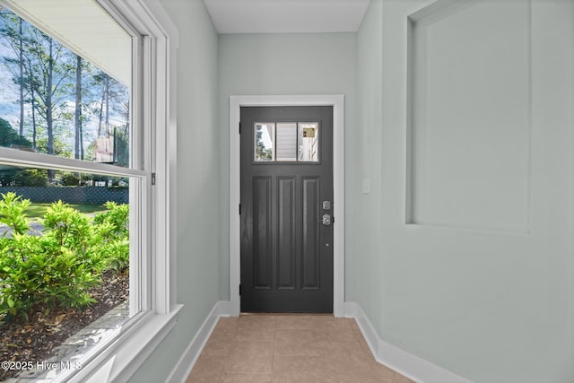 1129 Bennett Rd Unit 8B, Minnesott Beach, NC 28510 - doorway with baseboards, a healthy amount of sunlight, and light tile patterned flooring