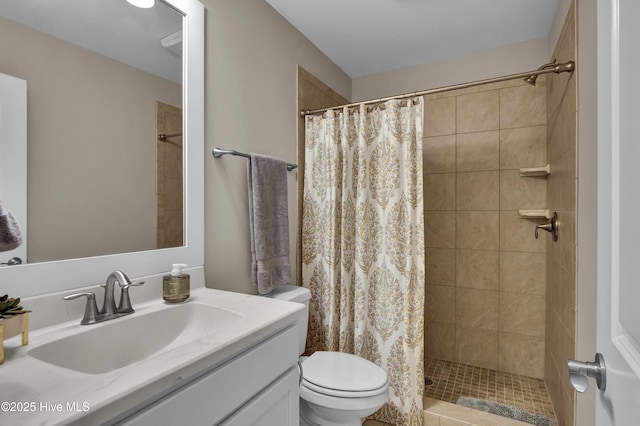 bathroom featuring toilet, a tile shower, and vanity