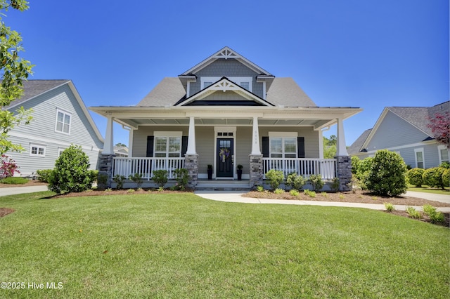 craftsman house with covered porch and a front lawn