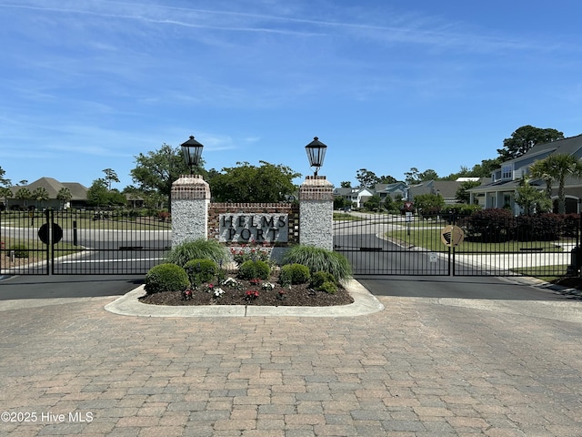 view of gate with a residential view and fence