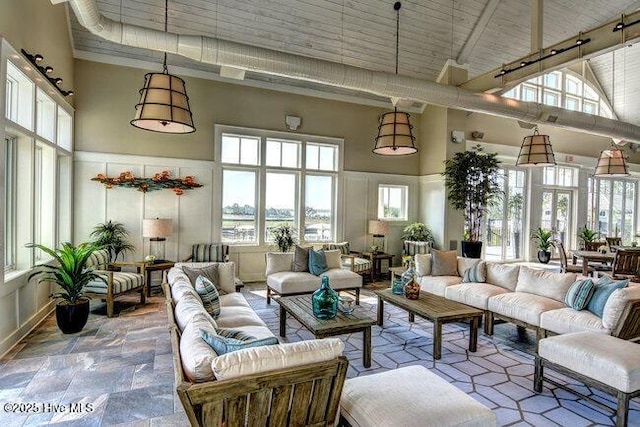 sunroom with plenty of natural light and track lighting