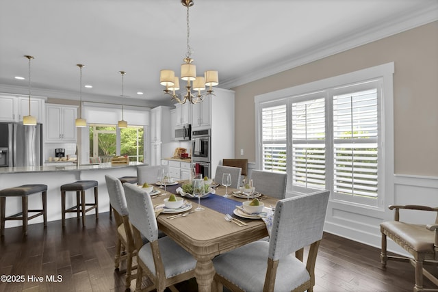 dining area with crown molding, a notable chandelier, wainscoting, recessed lighting, and dark wood-type flooring
