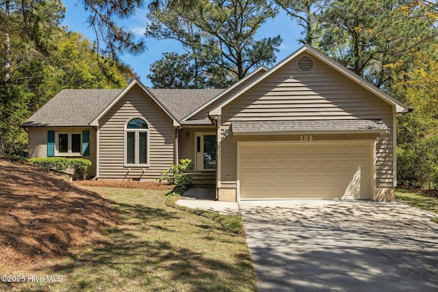 ranch-style house with a garage, roof with shingles, and concrete driveway