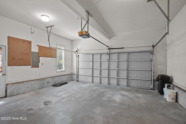 garage with electric panel and a garage door opener