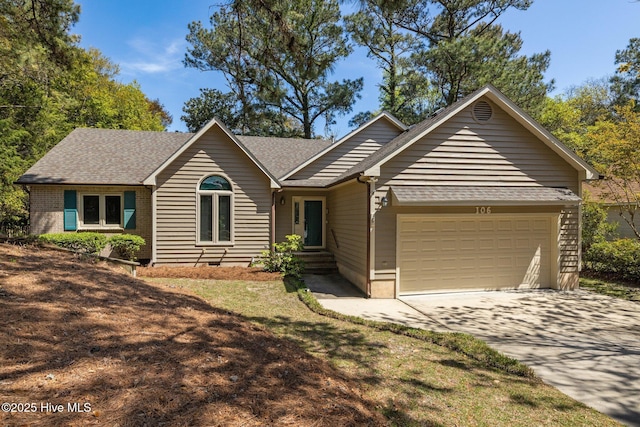 single story home with a garage, a shingled roof, and concrete driveway
