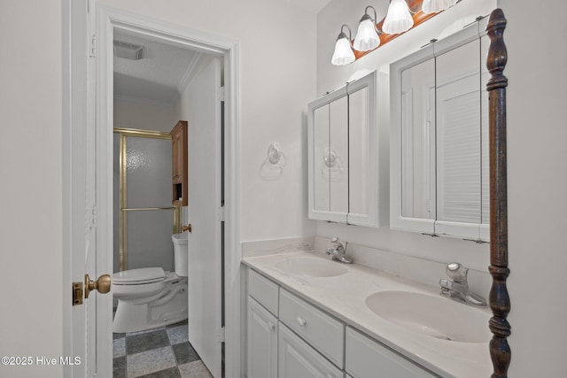 bathroom with a sink, ornamental molding, toilet, and double vanity