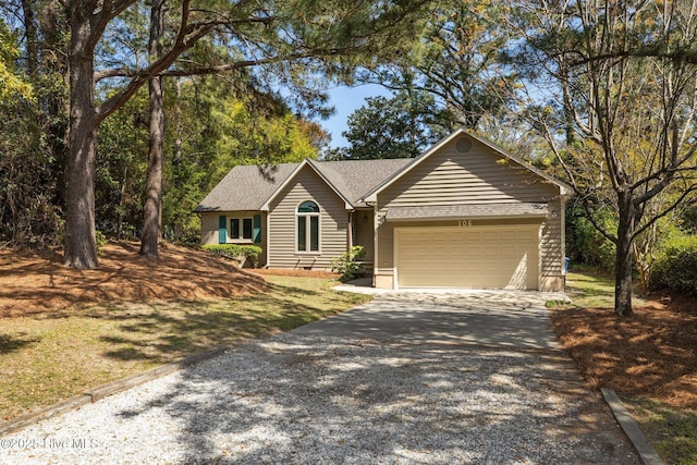 ranch-style home with an attached garage and driveway