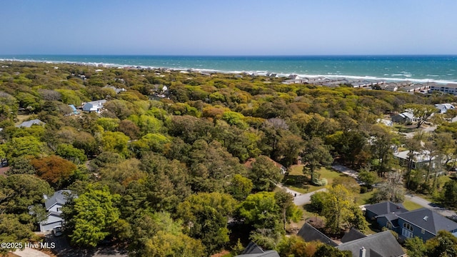 birds eye view of property with a water view and a wooded view
