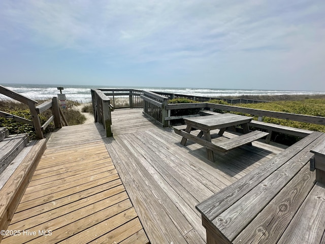 deck featuring a water view and a view of the beach