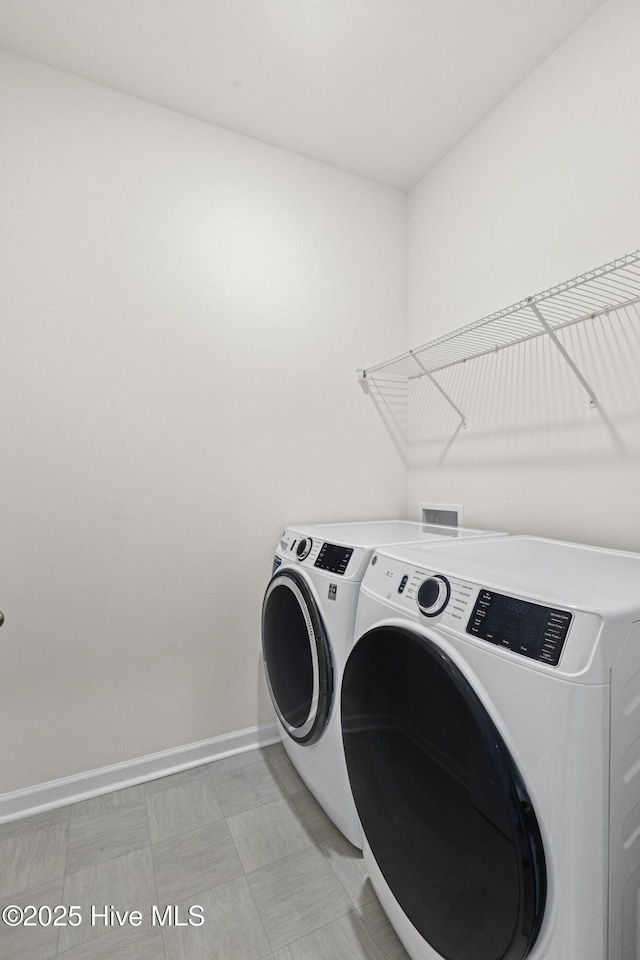 5900 Santo Domingo Ct, New Bern, NC 28560 - clothes washing area featuring baseboards, laundry area, washer and clothes dryer, and light floors