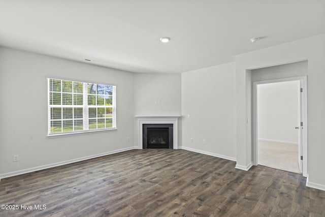 5900 Santo Domingo Ct, New Bern, NC 28560 - unfurnished living room featuring dark wood-type flooring, baseboards, visible vents, and a fireplace