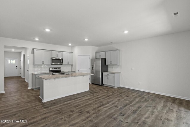 5900 Santo Domingo Ct, New Bern, NC 28560 - kitchen with a sink, dark wood finished floors, stainless steel appliances, backsplash, and a center island with sink