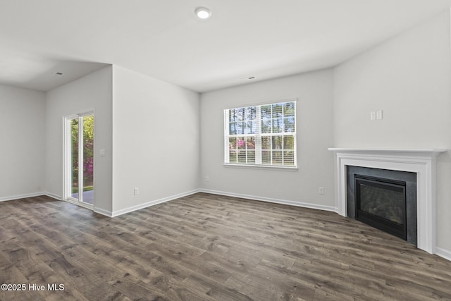 5900 Santo Domingo Ct, New Bern, NC 28560 - unfurnished living room featuring baseboards, dark wood-style floors, and a wealth of natural light