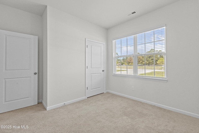 5900 Santo Domingo Ct, New Bern, NC 28560 - unfurnished bedroom with carpet floors, baseboards, and multiple windows