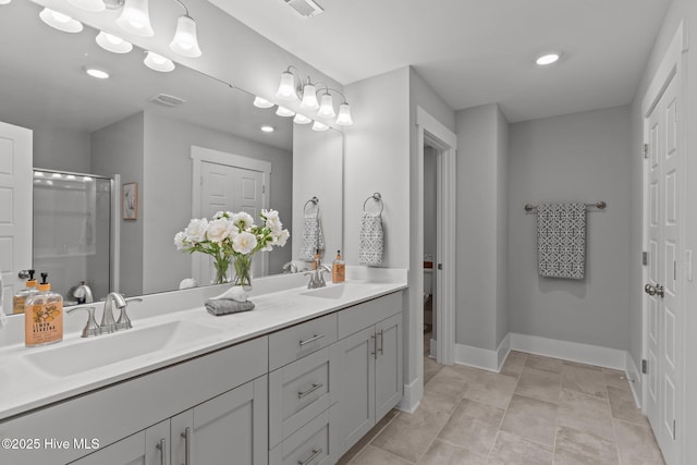 761 Cypress Village Pl, Wilmington, NC 28412 - bathroom with baseboards, a sink, a shower stall, and double vanity