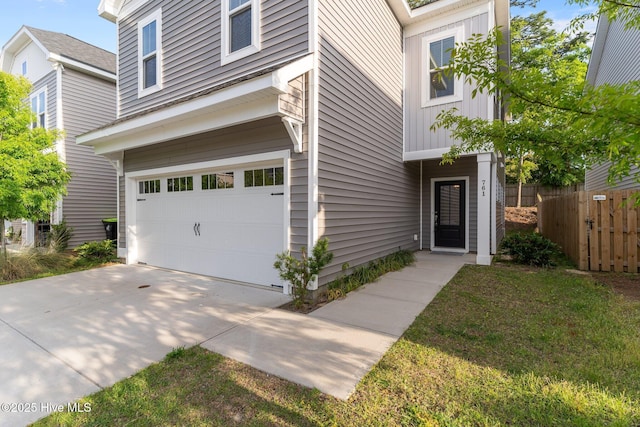 761 Cypress Village Pl, Wilmington, NC 28412 - traditional-style home with board and batten siding, an attached garage, concrete driveway, and fence