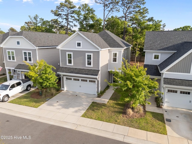 761 Cypress Village Pl, Wilmington, NC 28412 - view of front of home featuring roof with shingles, driveway, board and batten siding, and a garage