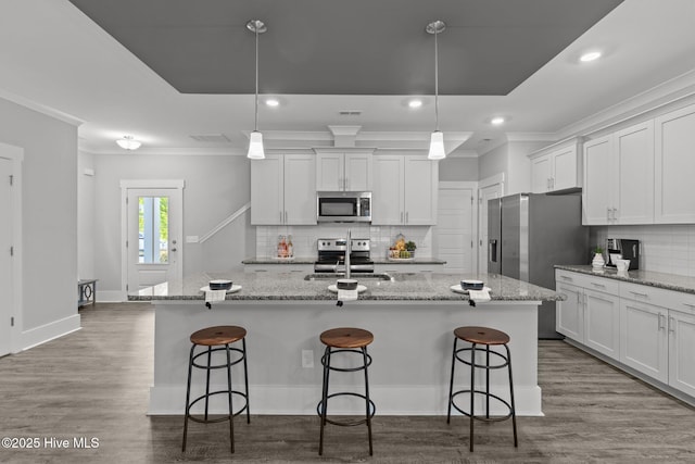 761 Cypress Village Pl, Wilmington, NC 28412 - kitchen featuring white cabinets, stainless steel appliances, ornamental molding, a sink, and decorative backsplash